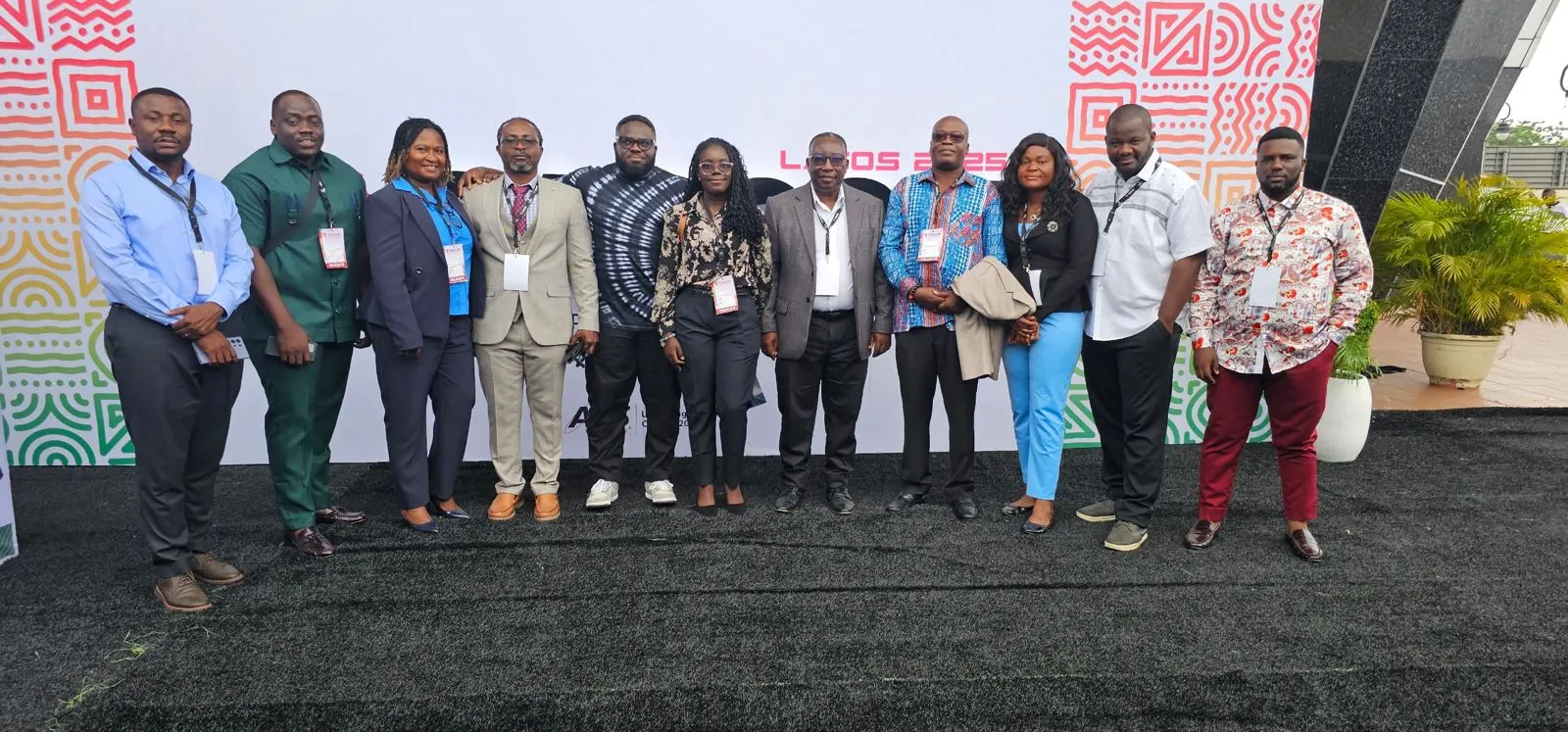 The Ghanaian delegation to the Lagos edition of SASCON, twelve people standing together in front of the conference backdrop.