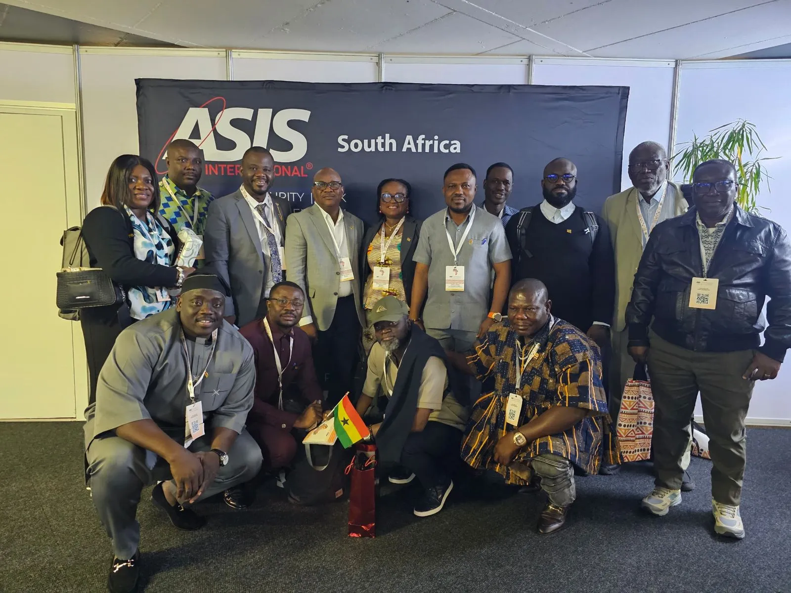 The Ghanaian delegation at the Cape Town edition of SASCON, grouped in front of an ASIS South Africa backdrop with a Ghana flag held at the front.