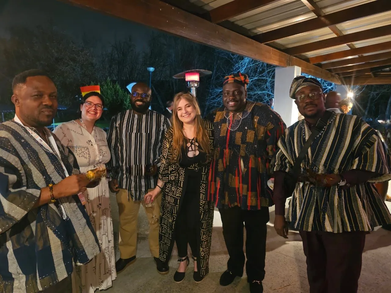 Delegates from several countries at a SASCON evening reception, standing together in Ghanaian smocks and other formal dress.