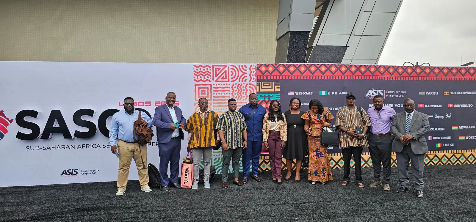 Des délégués alignés devant le lieu de l'édition de Lagos du SASCON, devant une banderole portant SASCON Lagos 2025, Sub-Saharan Africa Security Conference.